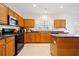 Bright kitchen with wooden cabinets, stainless steel appliances, and breakfast bar at 6068 Magnolia Rdg, Stone Mountain, GA 30087