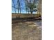 Fenced backyard with retaining walls and mature trees at 866 Indian Lake Nw Dr, Lilburn, GA 30047