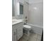 Standard bathroom features a vanity, toilet, tub, and shower at 866 Indian Lake Nw Dr, Lilburn, GA 30047