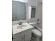 Bathroom with vanity, white cabinets, toilet, and tub at 866 Indian Lake Nw Dr, Lilburn, GA 30047