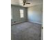 Bedroom featuring neutral walls, fan, windows, and gray carpet at 866 Indian Lake Nw Dr, Lilburn, GA 30047