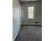 Bedroom featuring neutral walls, a window, and gray carpet at 866 Indian Lake Nw Dr, Lilburn, GA 30047