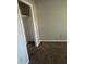 Empty bedroom featuring gray walls, carpet, and closet at 866 Indian Lake Nw Dr, Lilburn, GA 30047