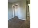 Empty bedroom features neutral walls, carpet, and closet at 866 Indian Lake Nw Dr, Lilburn, GA 30047