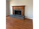 Close up of living room fireplace with hardwood floors at 866 Indian Lake Nw Dr, Lilburn, GA 30047