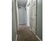 Hallway features neutral walls and carpeted floor at 866 Indian Lake Nw Dr, Lilburn, GA 30047