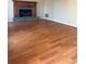 Spacious living room featuring hardwood floors and a cozy fireplace at 866 Indian Lake Nw Dr, Lilburn, GA 30047