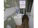 Bathroom featuring single sink, window and toilet at 2909 Diana Sw Dr, Atlanta, GA 30315