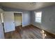 Bedroom featuring hardwood floors, blue walls, closet and a window at 2909 Diana Sw Dr, Atlanta, GA 30315