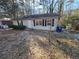 A quaint single-story house featuring a minimalist design and shaded by mature trees at 2909 Diana Sw Dr, Atlanta, GA 30315
