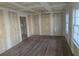 Bright living room featuring unfinished drywall, hardwood floors, and natural light from the windows at 2909 Diana Sw Dr, Atlanta, GA 30315
