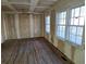 Inviting living room featuring unfinished drywall, hardwood floors, and natural light from the windows at 2909 Diana Sw Dr, Atlanta, GA 30315