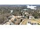 Aerial view of a residential area showcasing lake views, tree coverage, and community layout at 3825 Bishops Walk, Cumming, GA 30041