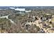 Aerial view of neighborhood homes nestled among mature trees with waterfront access at 3825 Bishops Walk, Cumming, GA 30041