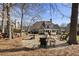 Beautiful backyard with a fire pit, inviting chairs, and views of the home's architecture at 3825 Bishops Walk, Cumming, GA 30041