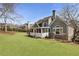 Spacious backyard showcasing the home's exterior, well-maintained lawn, and mature landscaping at 3825 Bishops Walk, Cumming, GA 30041