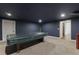 Basement game room with ping pong table and dark blue walls at 3825 Bishops Walk, Cumming, GA 30041