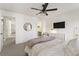 Spacious bedroom with plush bedding, ceiling fan, modern decor, and soft natural light at 3825 Bishops Walk, Cumming, GA 30041
