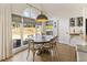 Charming breakfast nook with a large window, a round table, and convenient access to a wine storage and the backyard at 3825 Bishops Walk, Cumming, GA 30041