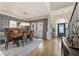 Formal dining area with a grand chandelier, a wooden table set, and lovely views of the front entrance at 3825 Bishops Walk, Cumming, GA 30041