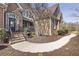 Charming two-story brick home with an arched entryway, landscaped front yard, and inviting facade at 3825 Bishops Walk, Cumming, GA 30041