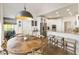 Bright eat-in kitchen with granite countertops, stainless steel appliances, and a modern light fixture at 3825 Bishops Walk, Cumming, GA 30041