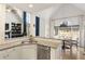 Bright kitchen with granite counters, white cabinetry, and an open view to the dining and living areas at 3825 Bishops Walk, Cumming, GA 30041