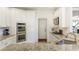 Modern kitchen equipped with stainless appliances, double ovens, and sleek granite countertops at 3825 Bishops Walk, Cumming, GA 30041
