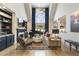 Spacious living room with a grand piano, fireplace, built-in bookshelves, and high ceilings with bright natural light at 3825 Bishops Walk, Cumming, GA 30041