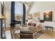 Bright living room featuring high ceilings, large windows, and a view into the kitchen, perfect for entertaining at 3825 Bishops Walk, Cumming, GA 30041