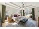 Serene main bedroom features tray ceilings, a ceiling fan, and ample natural light at 3825 Bishops Walk, Cumming, GA 30041