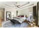 Spacious main bedroom boasts tray ceilings, soft lighting, and calming color scheme at 3825 Bishops Walk, Cumming, GA 30041