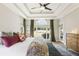 Comfortable main bedroom with large windows, tray ceiling, and elegant furnishings at 3825 Bishops Walk, Cumming, GA 30041