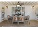 Charming covered outdoor dining area with rustic table, seating for six, and pleasant lighting at 3825 Bishops Walk, Cumming, GA 30041