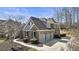 This two-story brick home features an attached three car garage and a lovely manicured yard at 3825 Bishops Walk, Cumming, GA 30041