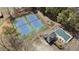 An aerial view of two tennis courts and a pool at 3825 Bishops Walk, Cumming, GA 30041