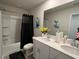 Well-lit bathroom with double sinks, modern fixtures, and a shower-tub combination at 4161 Dean Grove Way, Loganville, GA 30052