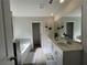 Bright and spacious bathroom with double sinks, a soaking tub, and stylish tile flooring at 4161 Dean Grove Way, Loganville, GA 30052