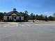 Exterior view of the community clubhouse featuring parking, pool access, and recreational space at 4161 Dean Grove Way, Loganville, GA 30052