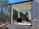 Covered patio showcasing the outdoor grill and a view of the private backyard at 4161 Dean Grove Way, Loganville, GA 30052