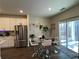 Kitchen and dining area featuring stainless steel appliances and a glass table with chairs at 4161 Dean Grove Way, Loganville, GA 30052