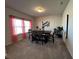 Bright dining room with modern table, chairs, art, and stylish window treatments at 4161 Dean Grove Way, Loganville, GA 30052