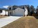 Two-story house with a concrete driveway, attached garage, and a freshly sodded yard at 4161 Dean Grove Way, Loganville, GA 30052