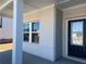 Covered porch leading to a front door and window showing the beautiful brick exterior at 4161 Dean Grove Way, Loganville, GA 30052