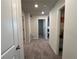 Hallway with carpet and white walls, leading to multiple rooms at 4161 Dean Grove Way, Loganville, GA 30052
