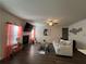Open-concept living room with a fireplace, TV, comfortable sofa, and stylish decor at 4161 Dean Grove Way, Loganville, GA 30052