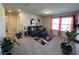 Cozy living room with comfortable seating, a colorful rug, bright windows, and indoor plants at 4161 Dean Grove Way, Loganville, GA 30052