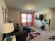 Cozy living room featuring a comfortable couch, modern decor, and natural light at 4161 Dean Grove Way, Loganville, GA 30052