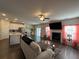 Spacious living room with kitchen view, fireplace, TV, stylish decor, and sliding glass doors at 4161 Dean Grove Way, Loganville, GA 30052