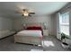 Bright main bedroom with a large bed, neutral colors, and carpet floors with ceiling fan at 4161 Dean Grove Way, Loganville, GA 30052